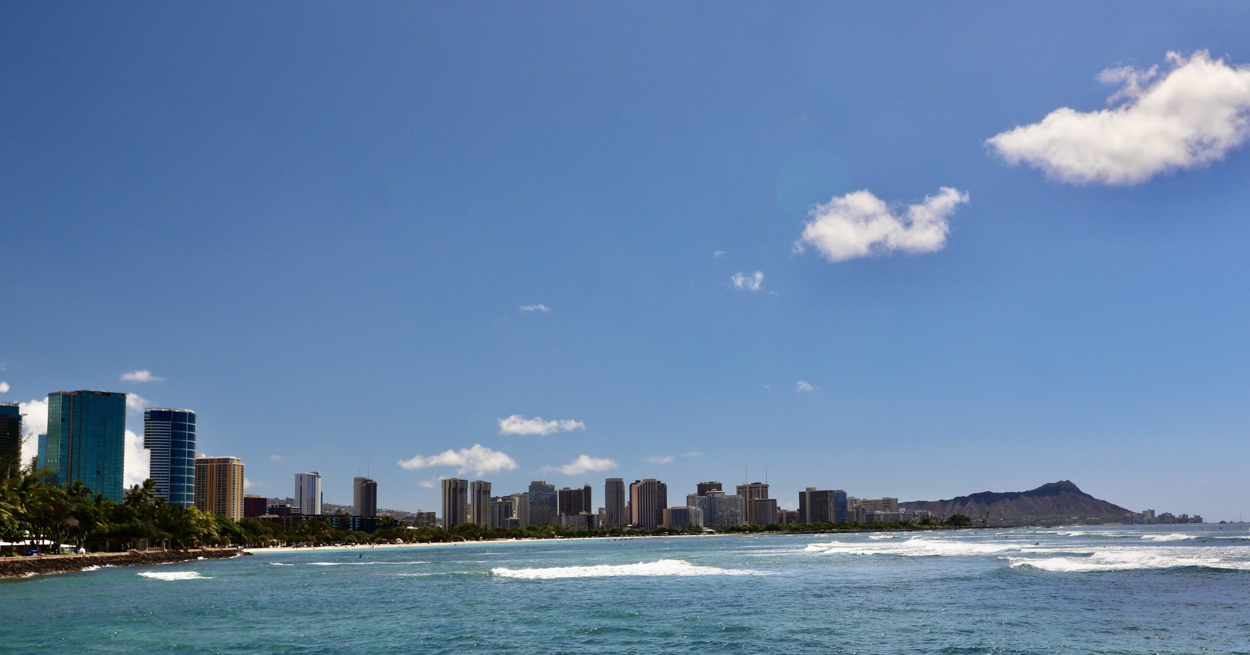 Honolulu skyline with Diamond Head in the distance on a clear blue day
